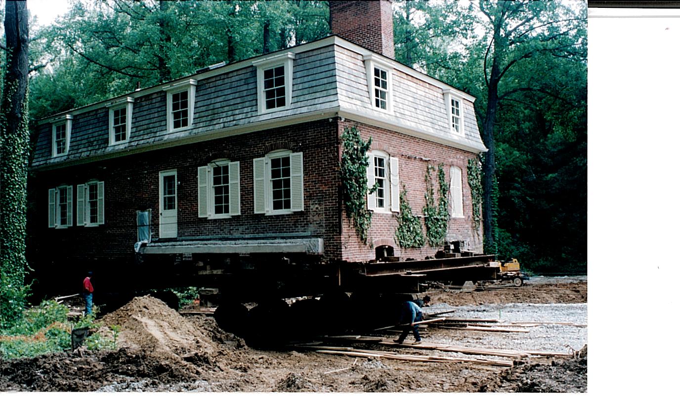 Two story brick house raised on dolly.