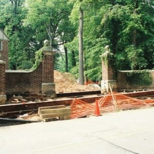Entrance way brick pillars with vines lifted on steel beams.
