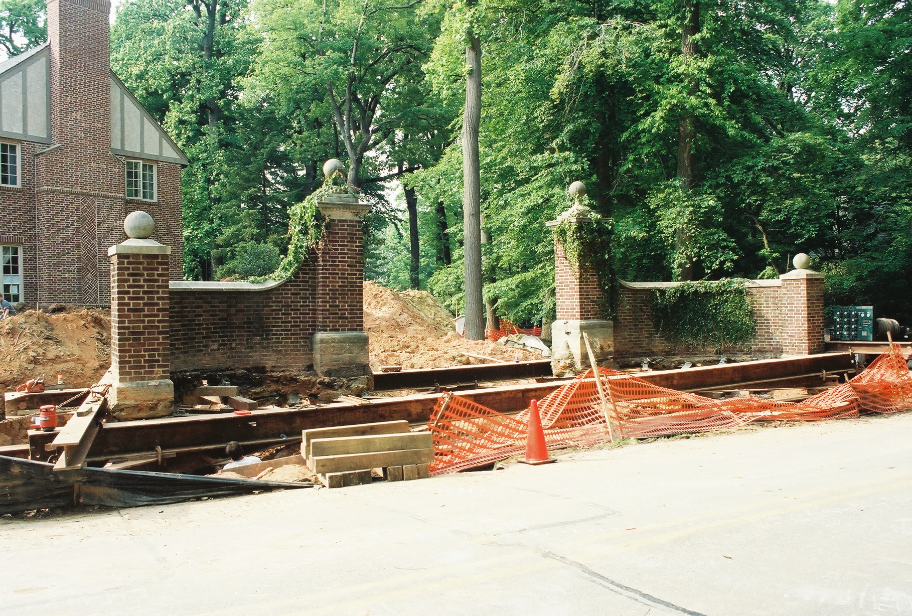 Entrance way brick pillars with vines lifted on steel beams.