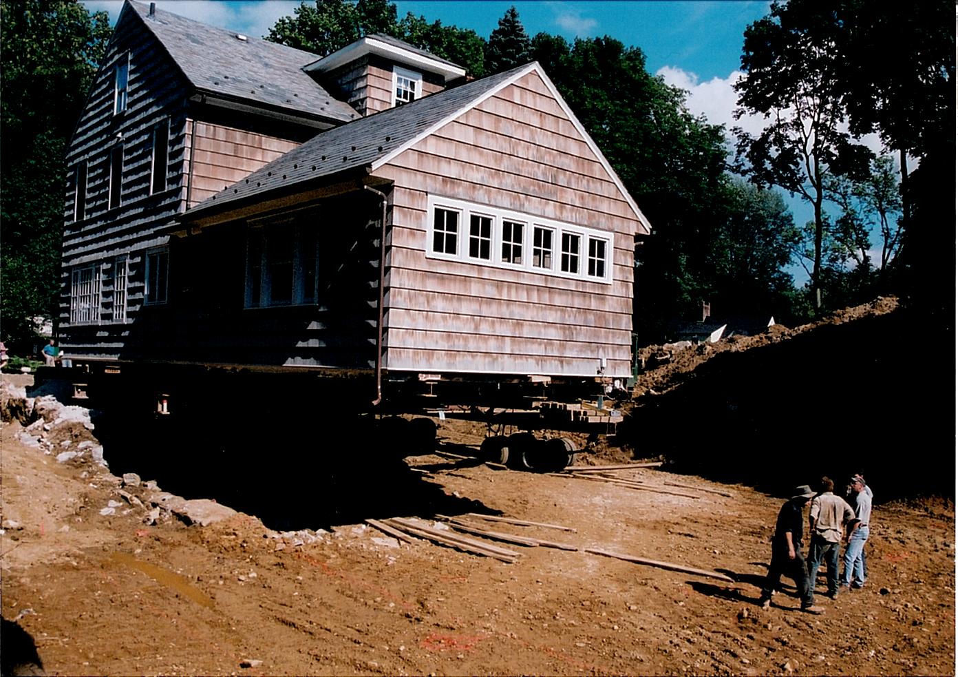 Oldstyle two story house with garage attatched raised on dolly.