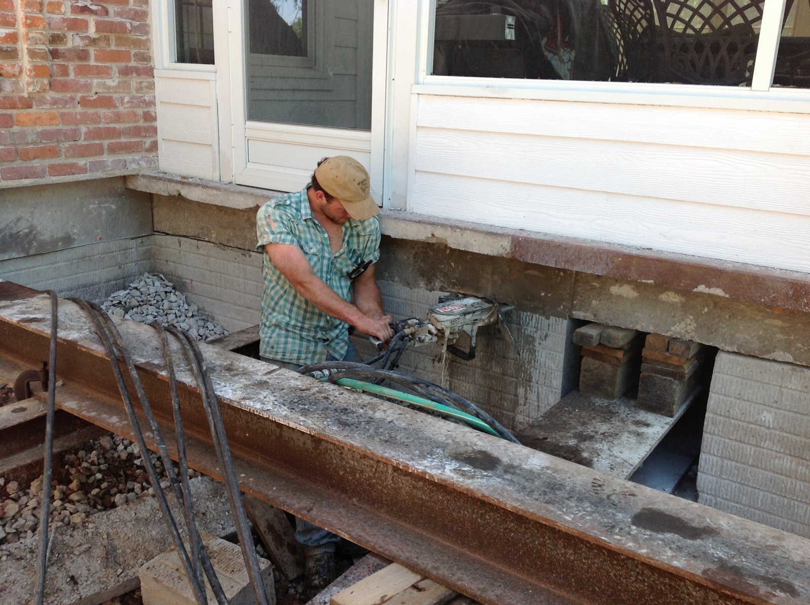 cutting away the foundation for house lifting project in Golden, MO 