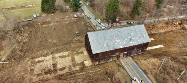 Historic Hilton Barn ariel view of barn being carried on dolly across road.