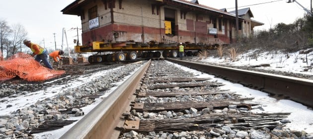 P&N Thrift Depot moving across railroad tracks.