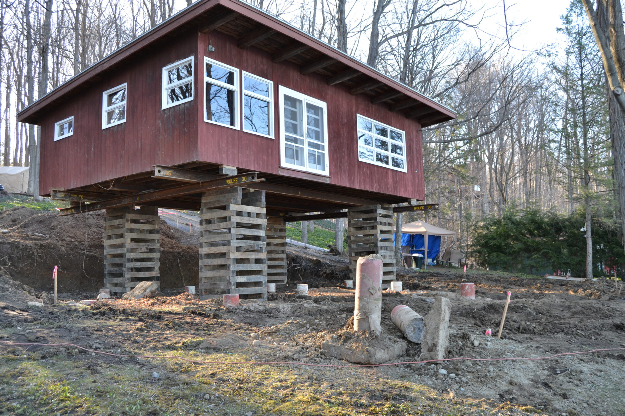 Finger Lakes Cabin Lifted on wooden supports.