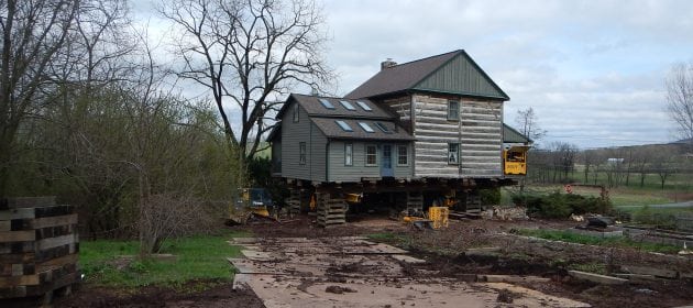 Log House raised on wooden supports.