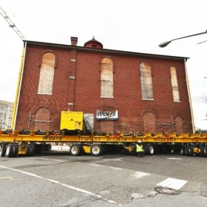 Side view of Jewish historic synagogue moving on turning dolly.