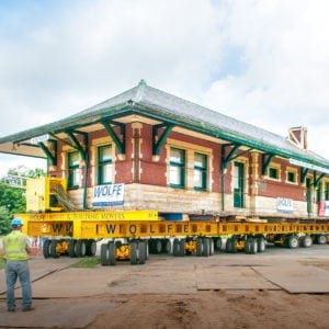 Sturgis Railroad, on a dolly, moving between a paved road and a dirt path.