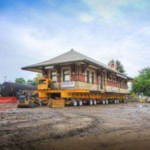 Sturgis Railroad depot moving on ground through muddy conditions.