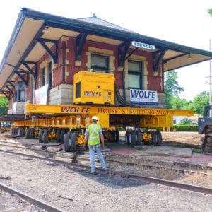 Sturgis Railroad depot moving on a dolly across train tracks.