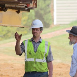 Crew member talking with local amishman.