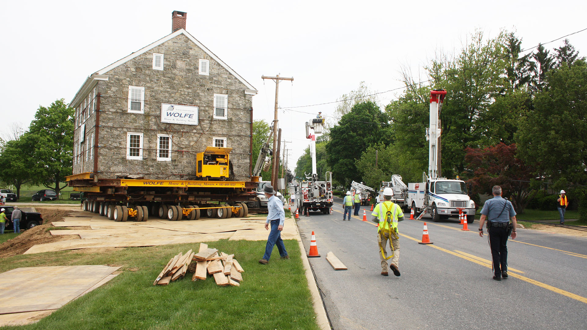 Landisville Stone House, a three and a half story building, moving on a dolly.