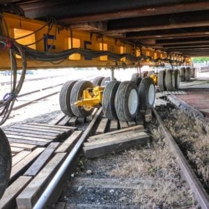 Wooden beams laid out to allow a dolly to roll across a rail road smoothly.