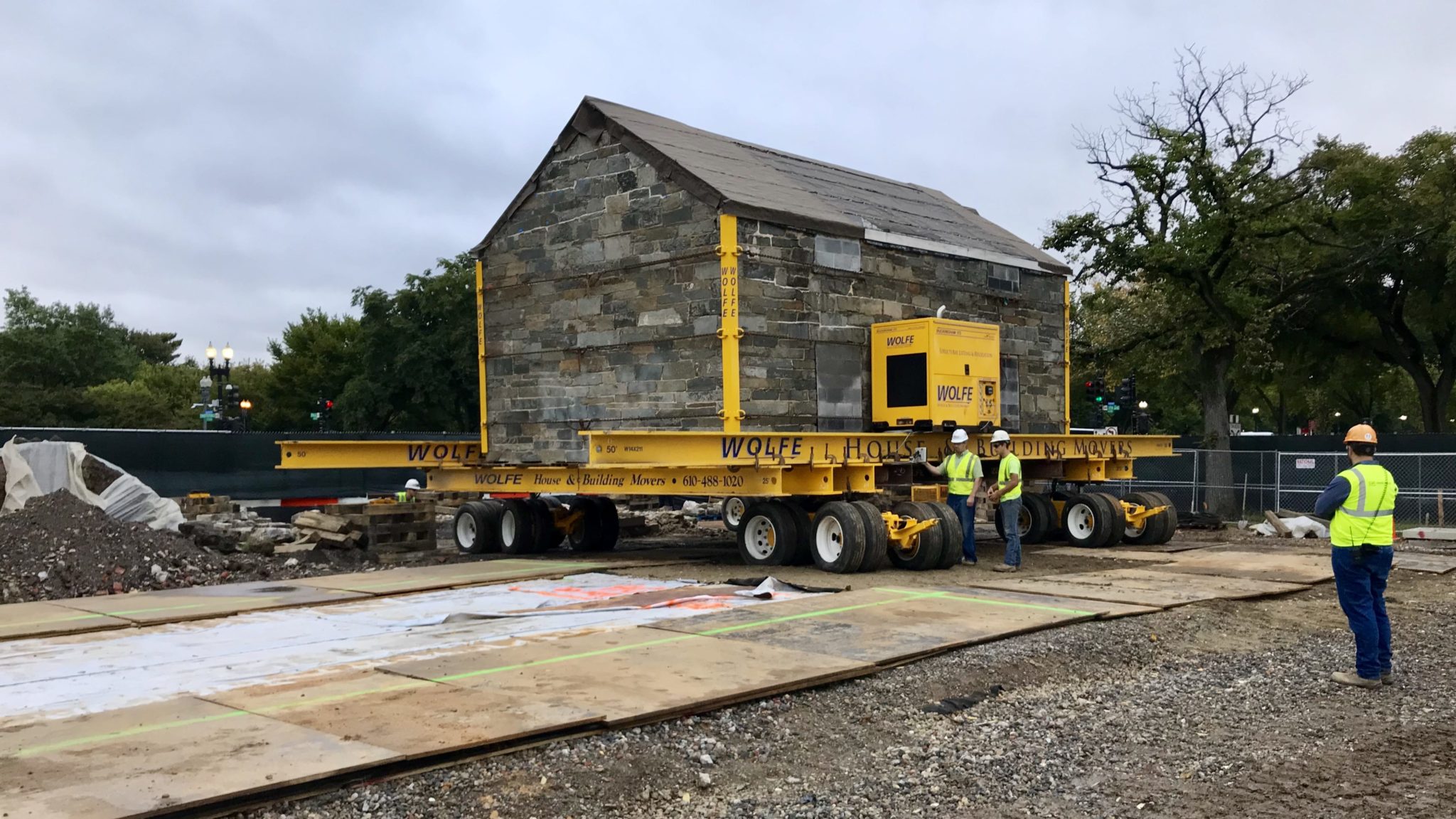 Small, stone building moving on a power dolly system.