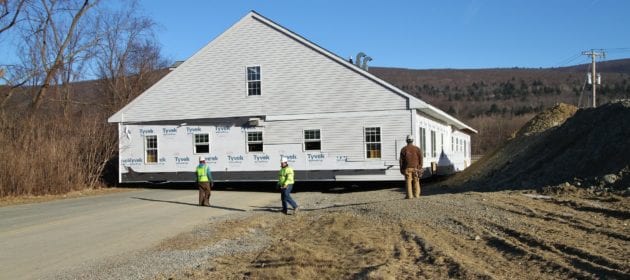 Crew next to harriman building raised off ground.