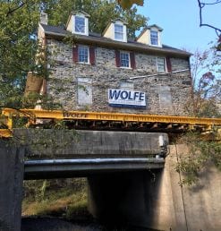 moving-stone-building-across-bridge