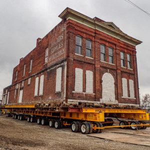 Corner view of historic brick building on dolly.