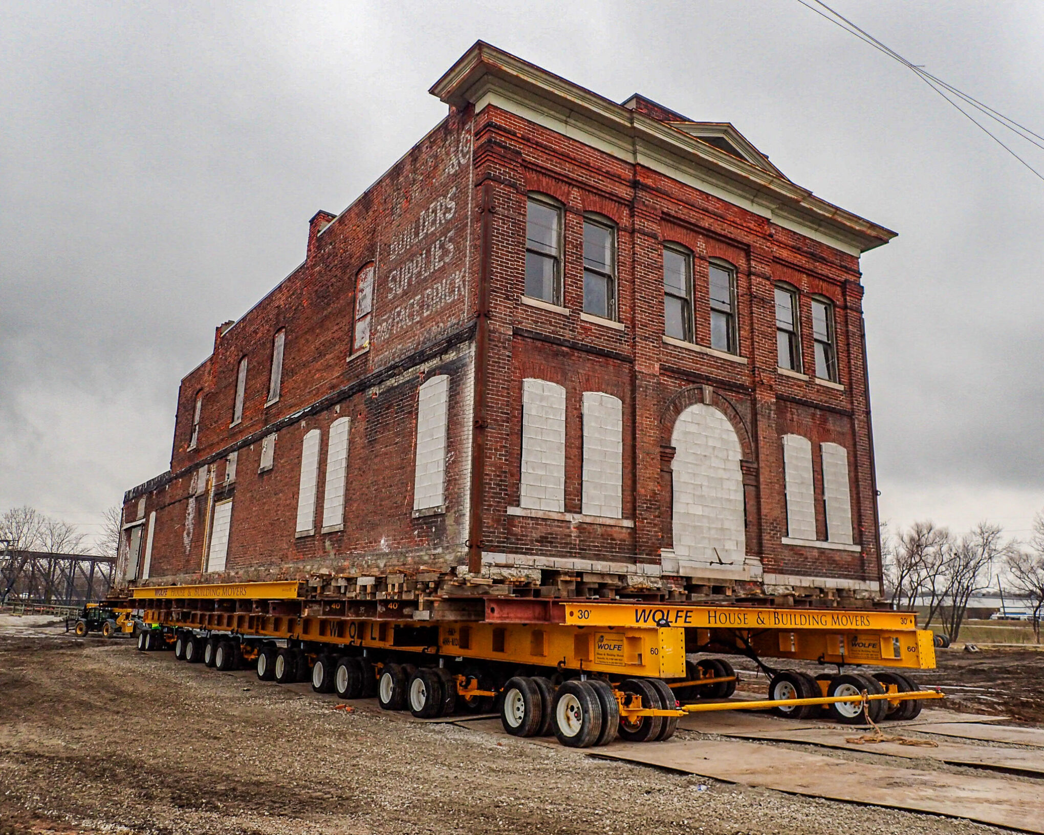 Corner view of historic brick building on dolly.