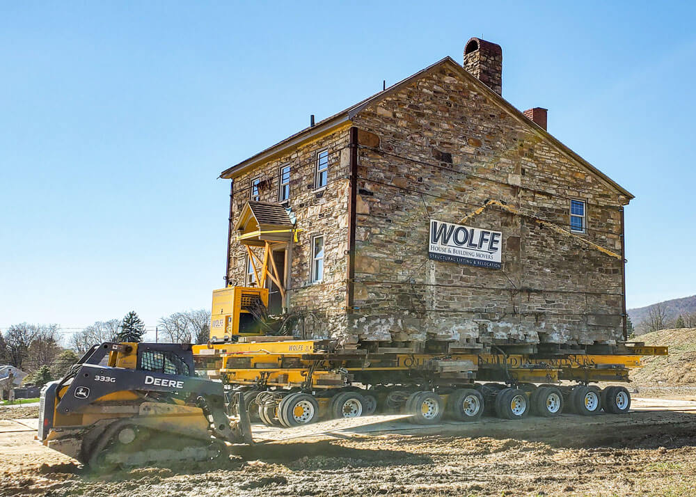 Enola Miller House with skid steers