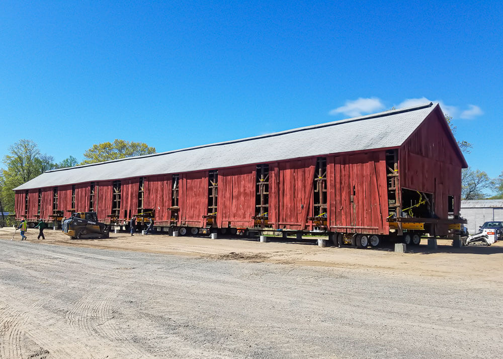 Wolfe moves a 31'x169' tobacco barn through a parking lot
