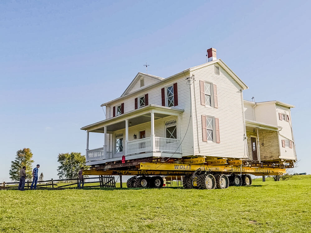 Virginia farmhouse rolling across pasture to new location