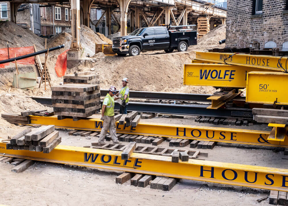 Workers stack crib for the Vautravers Building