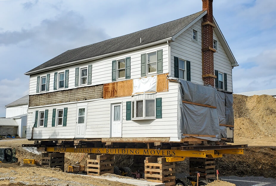 Frame Farmhouse Sitting Over New Footers