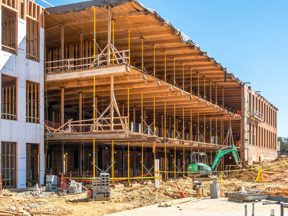 Three-story brick building supported by jacking-shoring posts