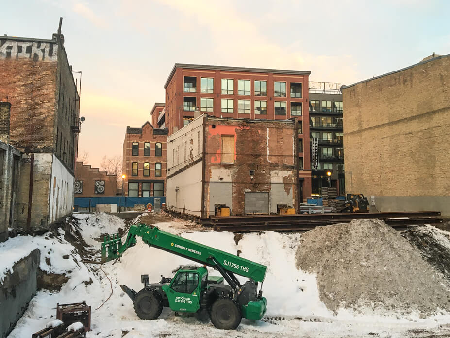 Wolfe installs beams under a brick building 