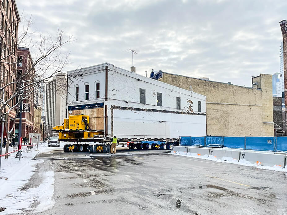 a brick building pulls out into the street