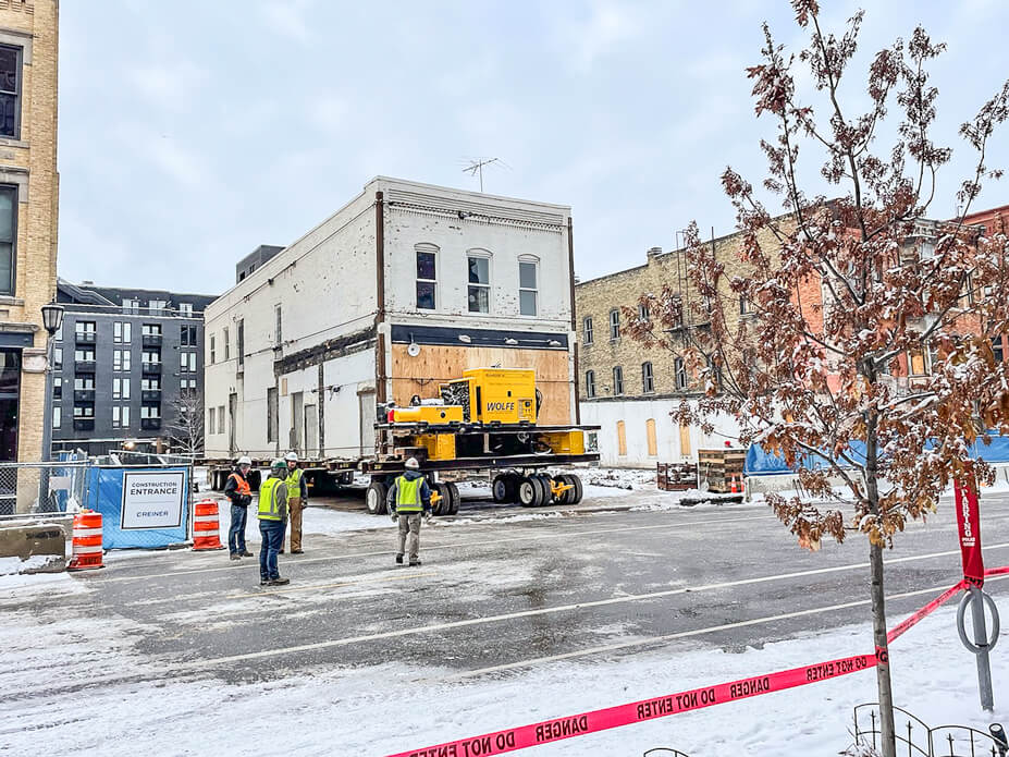 A brick building is driven to its new location