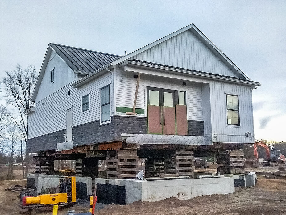 Sales center sits on crib over new foundation