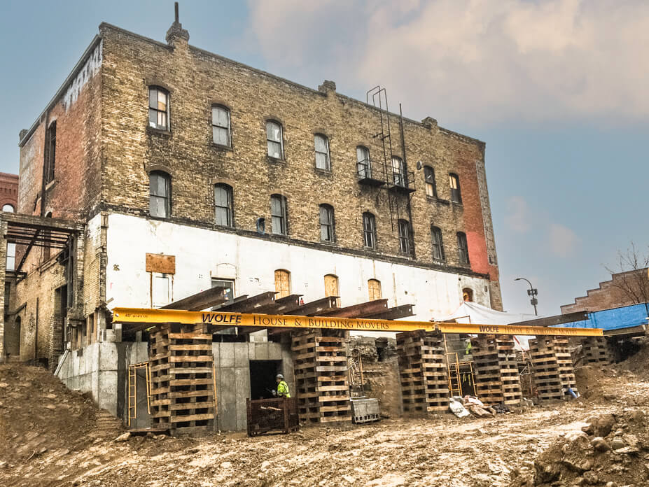 Wolfe supports a wall of a 3-story brick building with crib piles and steel beams