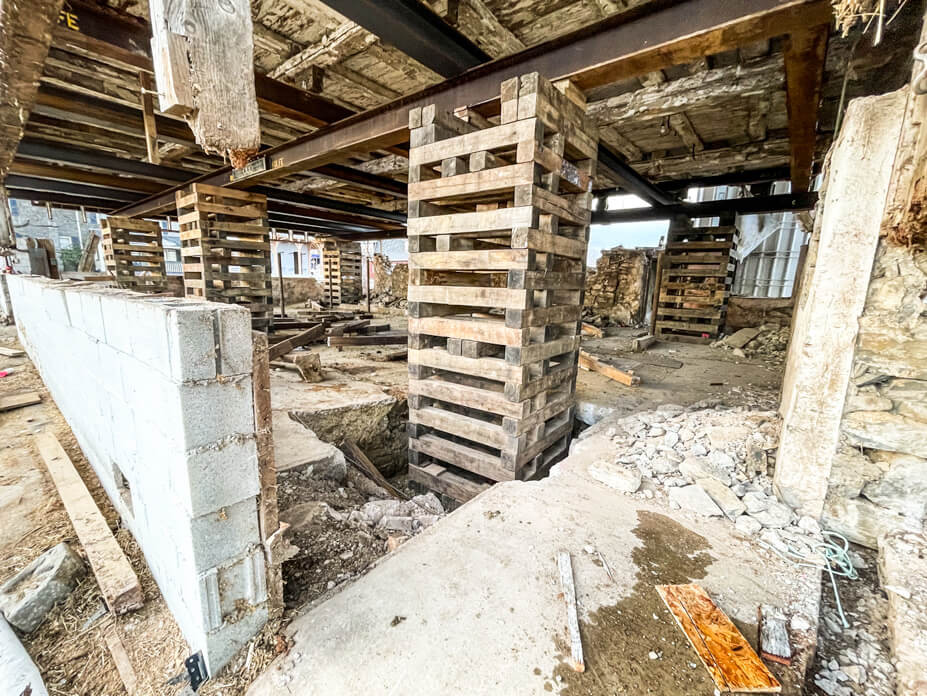 Cribbing piles support timber frame barn