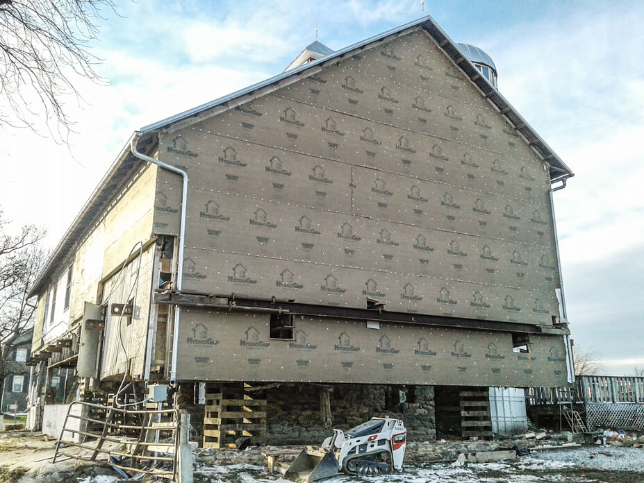 Timber frame barn is lifted for new foundation