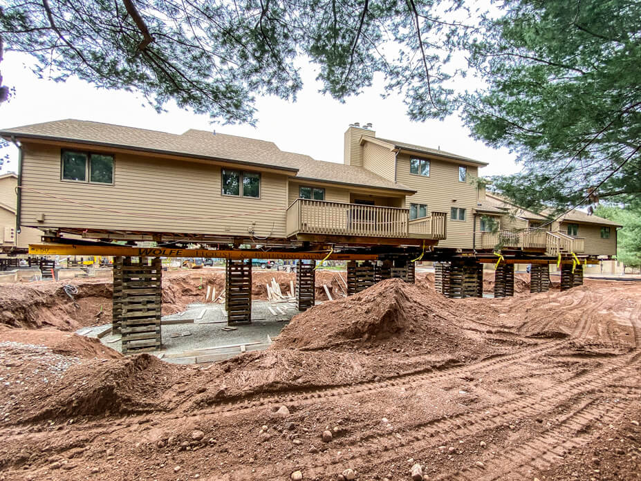 Condominium unit rests on crib piles while new foundation is built under it