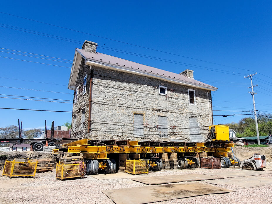 Stone house on dollies is ready to be moved