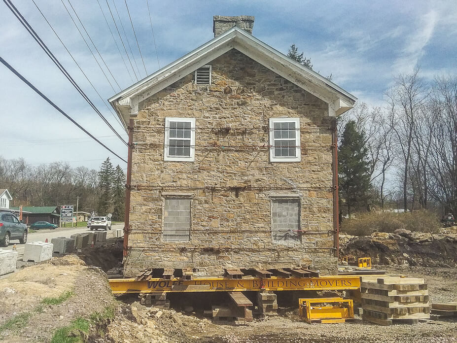 End view of stone house with steel beams