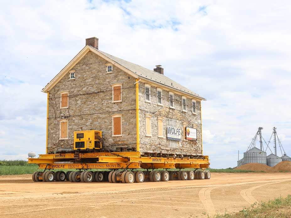 Farmhouse moves on dollies to avoid demolition