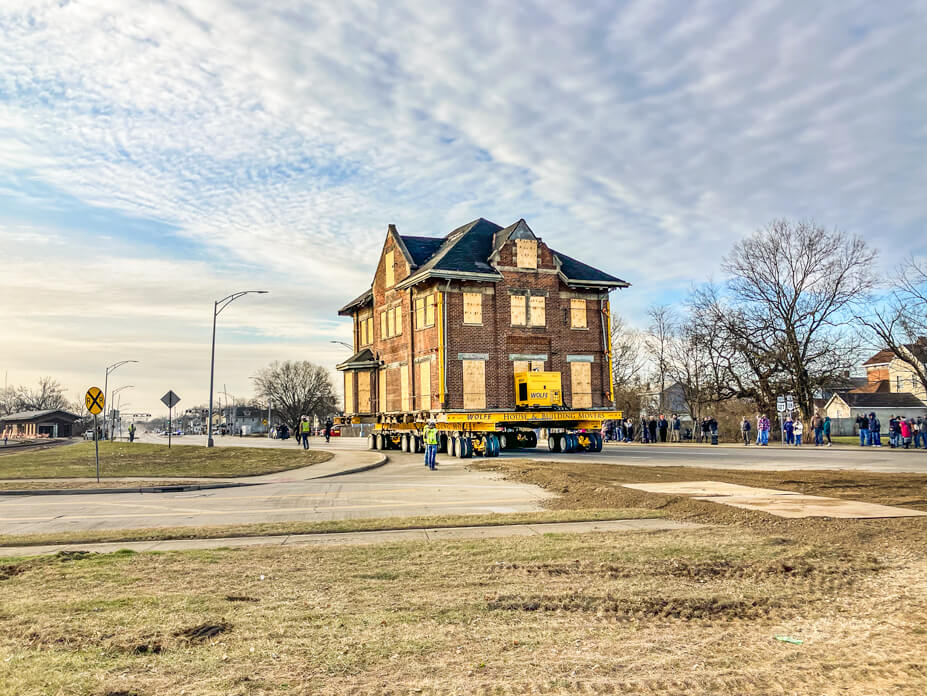 The original 2-story Hamilton Depot is carried down the road by housemoving dollies