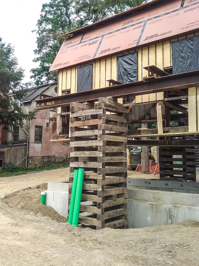 A crib pile supports a steel beam under Wolfe's barn lift