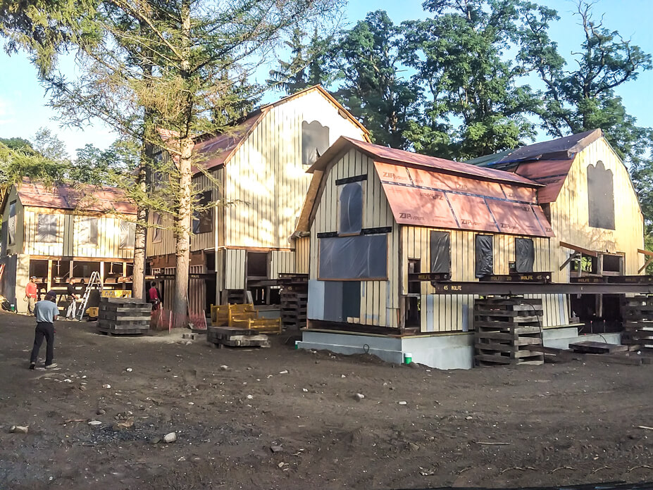 Steel beams protrude through the windows of a barn 