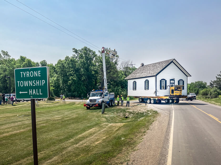 The white frame Tyrone Township Building pulls out into the street