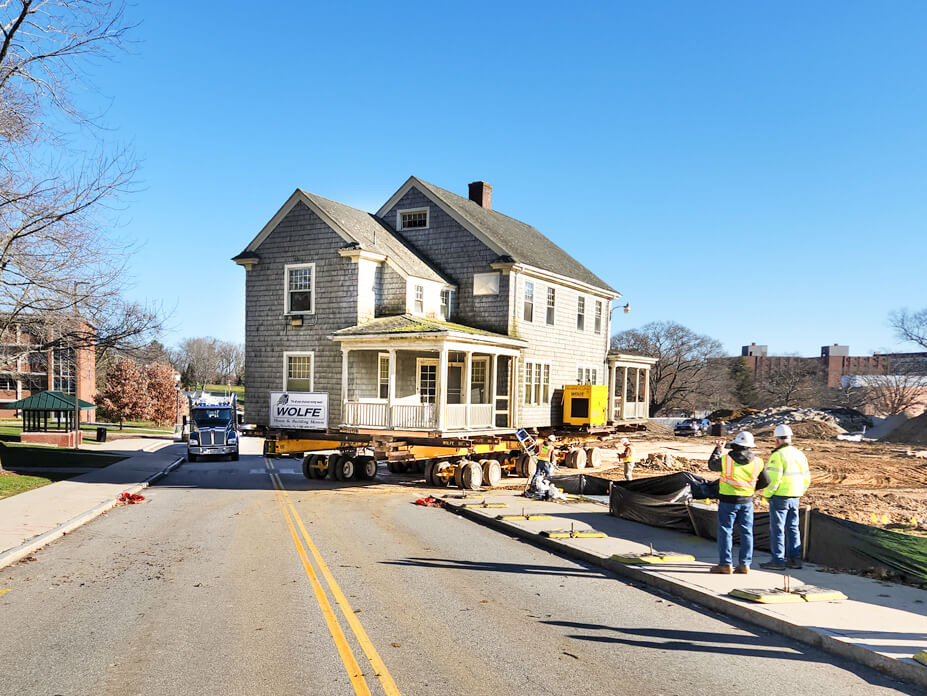 Wolfe House Movers drives UConn house from street into storage location