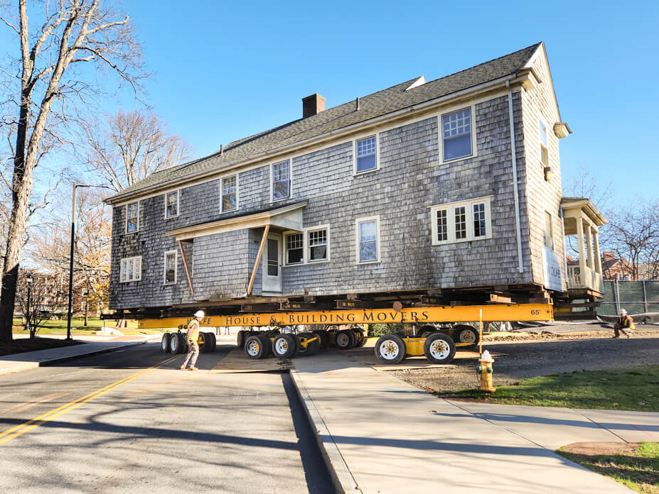 House on dollies is driven from street to storage location