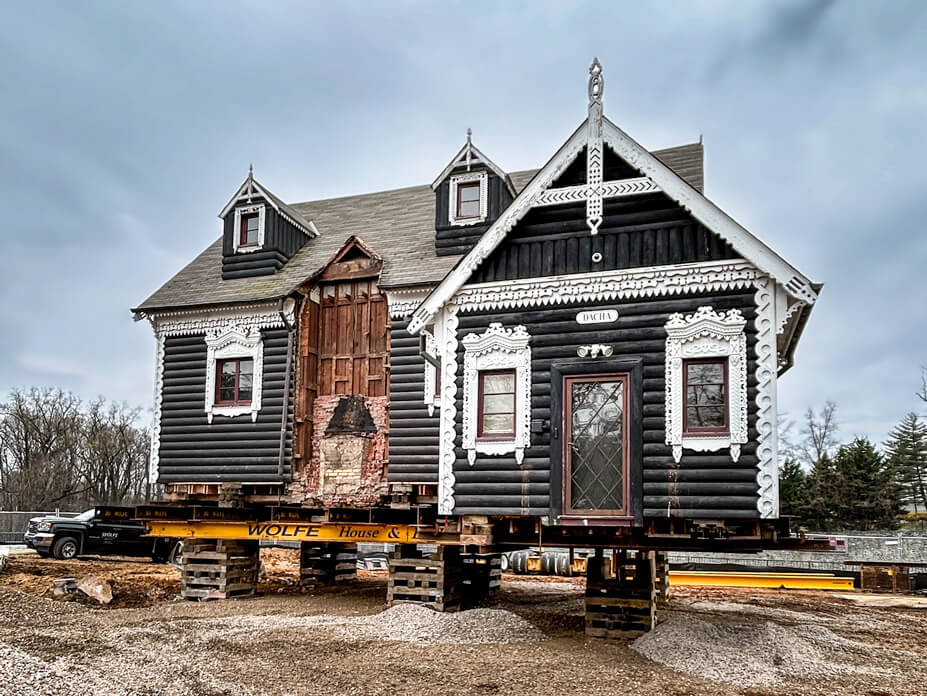 Dacha sits on cribbing prior to being relocated across campus