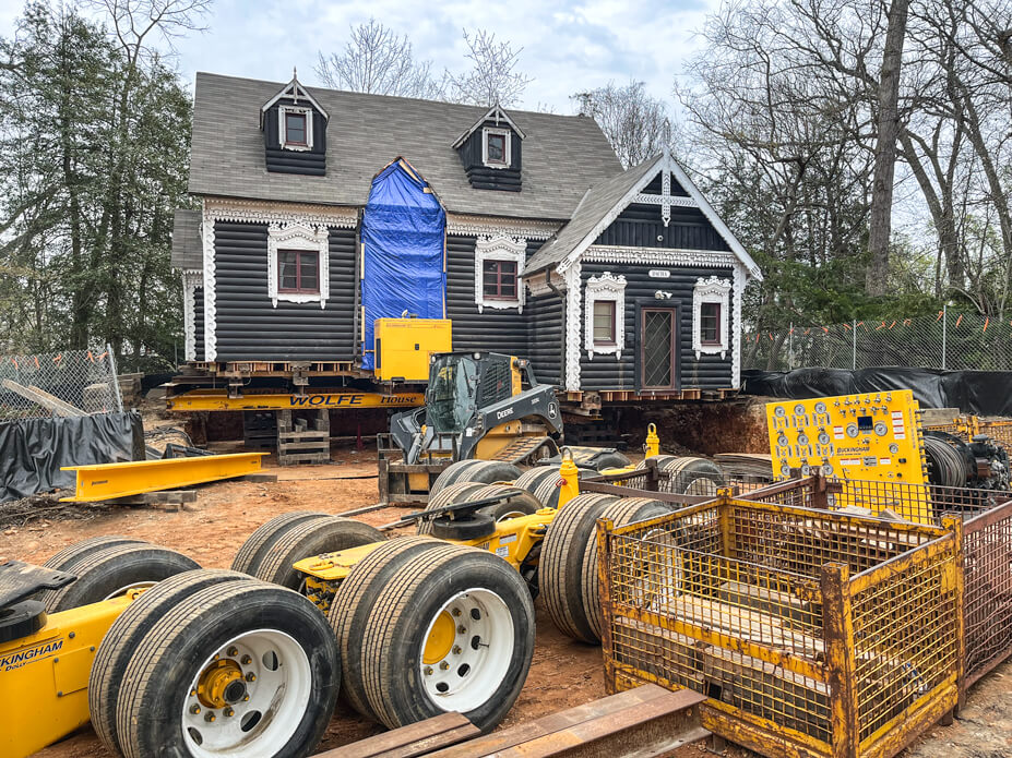 Daha sits on cribbing in new location, with Wolfe dollies and jacking machine in foreground