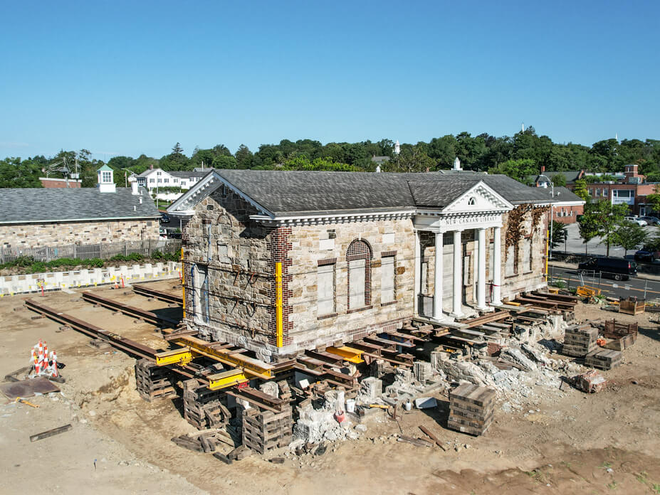 Drone shot of historic New Canaan library ready to be moved on steel beams