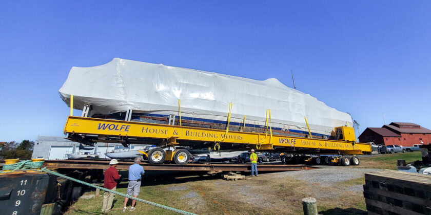 Buckingham dollies drive the shrinkwrapped USS Sequoia onto a barge for transport from Maine to Maryland.