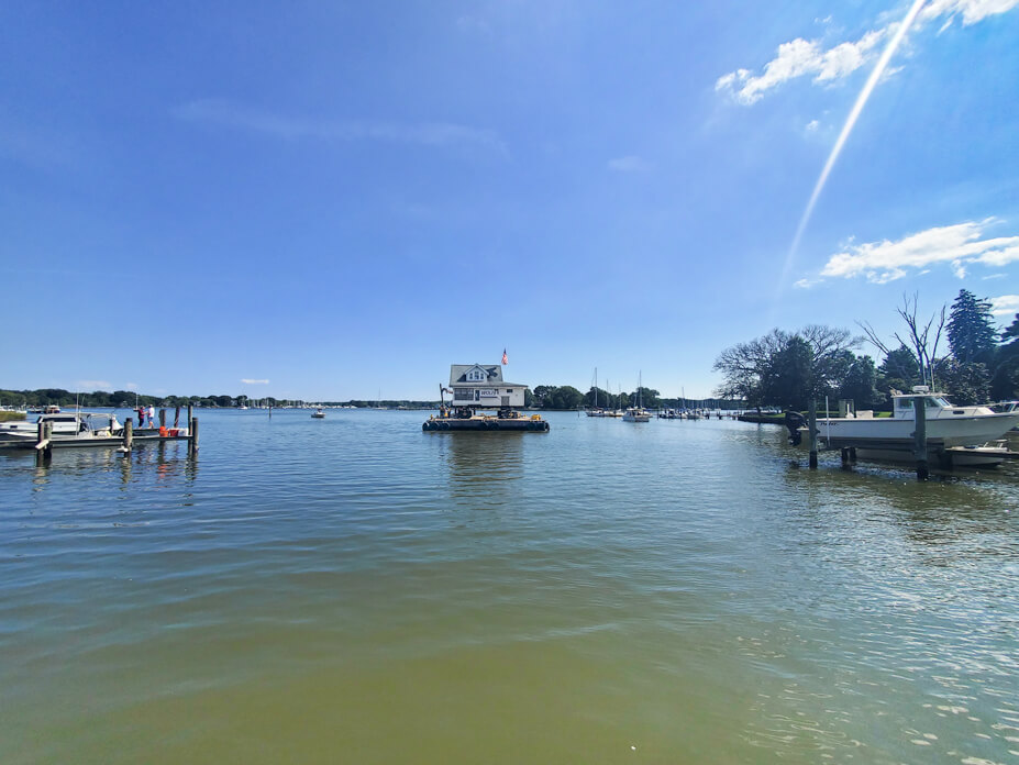 West River with house on barge for relocation