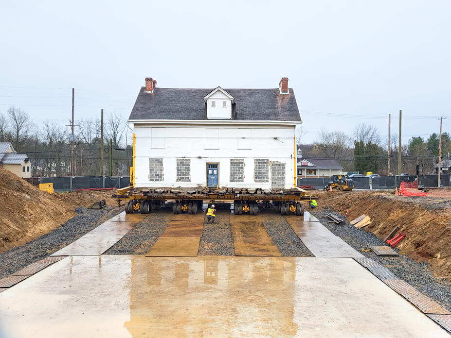 New foundation pad for Cox house with house in the background